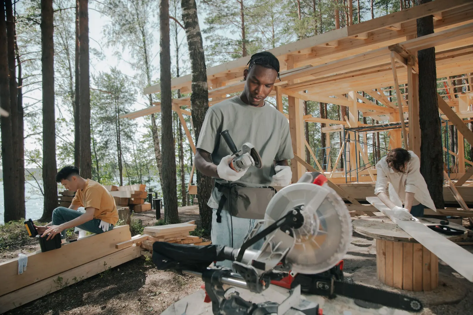 A three-person crew framing a wood structure on site